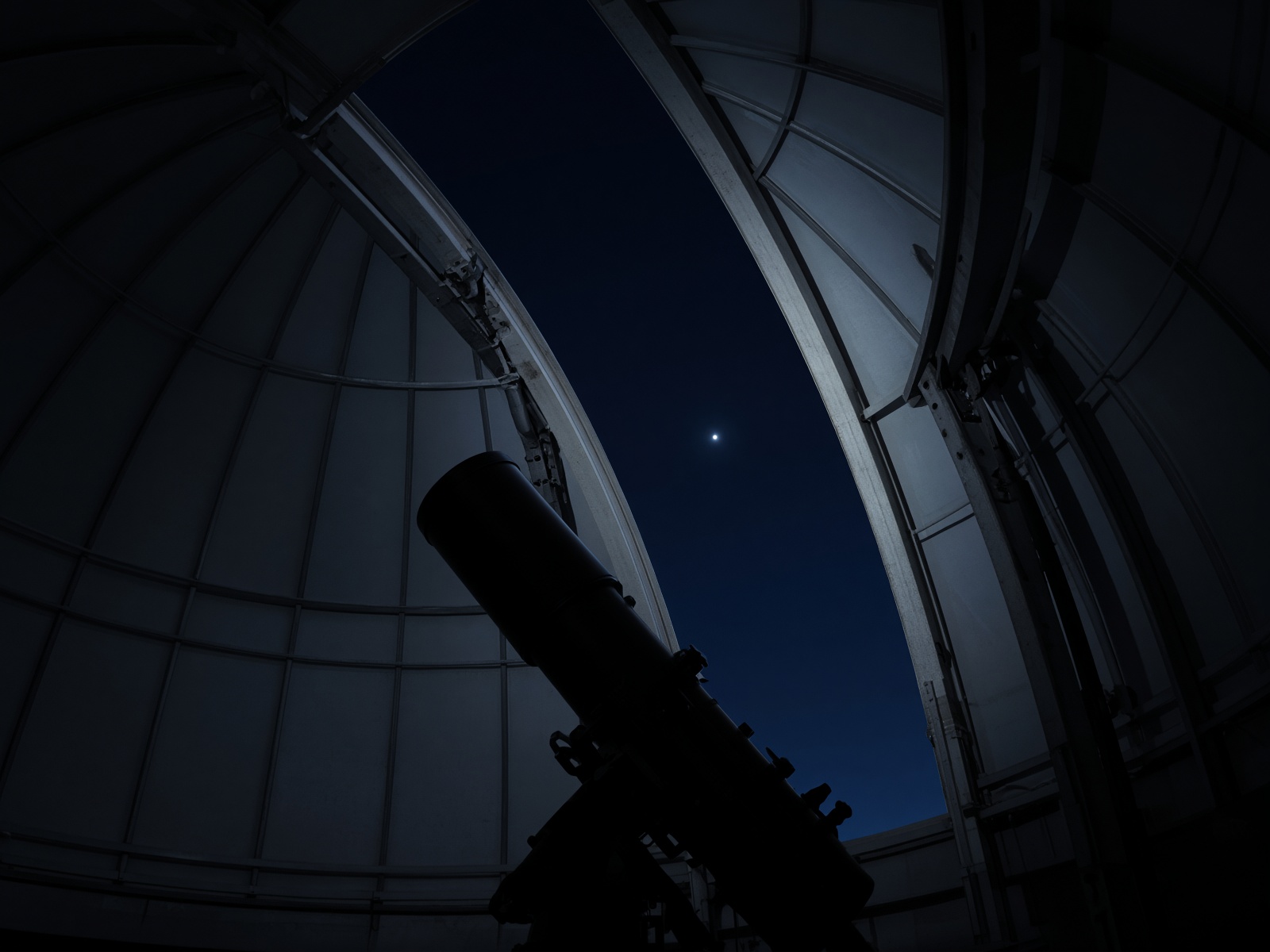 An observatory dome slit open to a single bright star.
